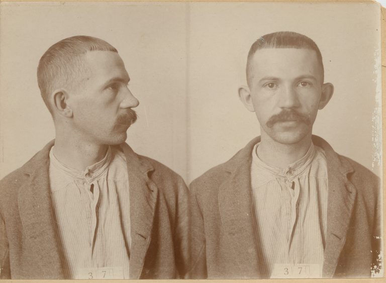 Two sepia photos of Holzhey side by side. One is a profile view of his face, the other straight on.