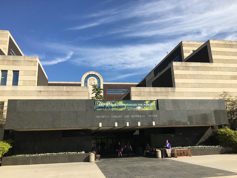 Large 5-story building with a granite overhang over the entrance.